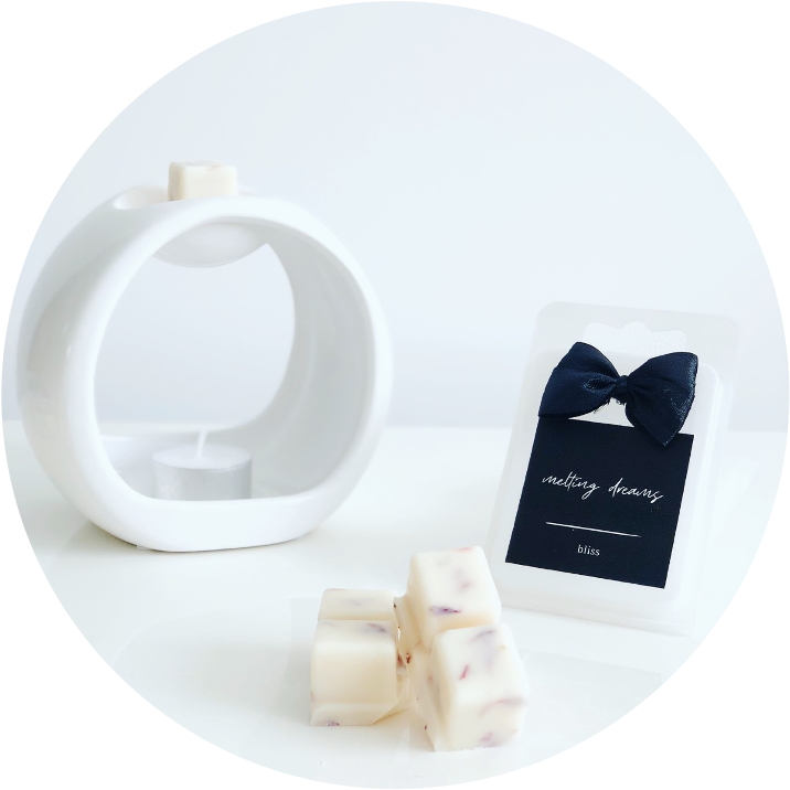 Luxury home fragrance. Highly fragranced wax melts with dried botanicals. Black label. White oval wax melt burner with tea-light.