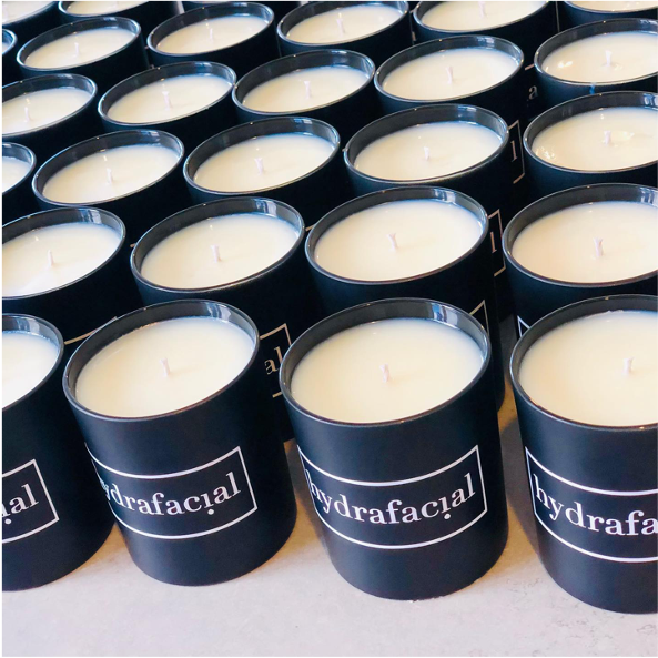 Luxury scented candles. black jar with Hydrafacial logo. 