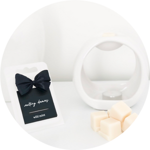 Luxury home fragrance soy wax melts with black label and white oval wax melt burner. 