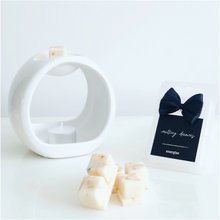 Load image into Gallery viewer, Luxury botanical energise wax melts with a black label and white wax burner. 
