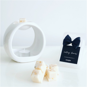 Luxury botanical energise wax melts with a black label and white wax burner. 