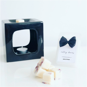 Luxury botanical peony & blush wax melts with a white label and black wax burner. 