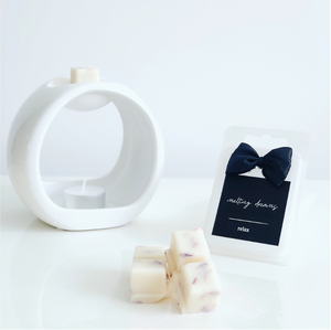 Luxury botanical relax wax melts with a black label and white wax burner. 