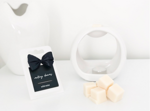 Luxury wild mint wax melts with a black label and white wax burner. 